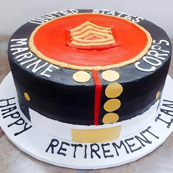 A round cake decorated as a United States Marine Corps uniform, with "Happy Retirement" written on the base.